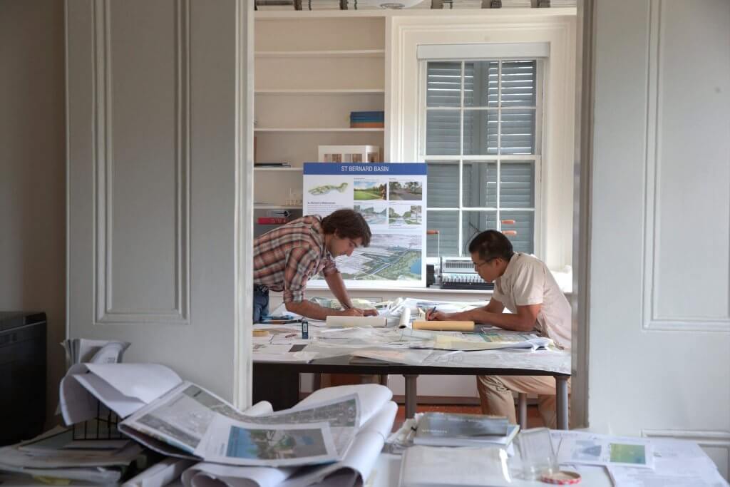 Waggoner and Ball working diligently on blueprints in a home