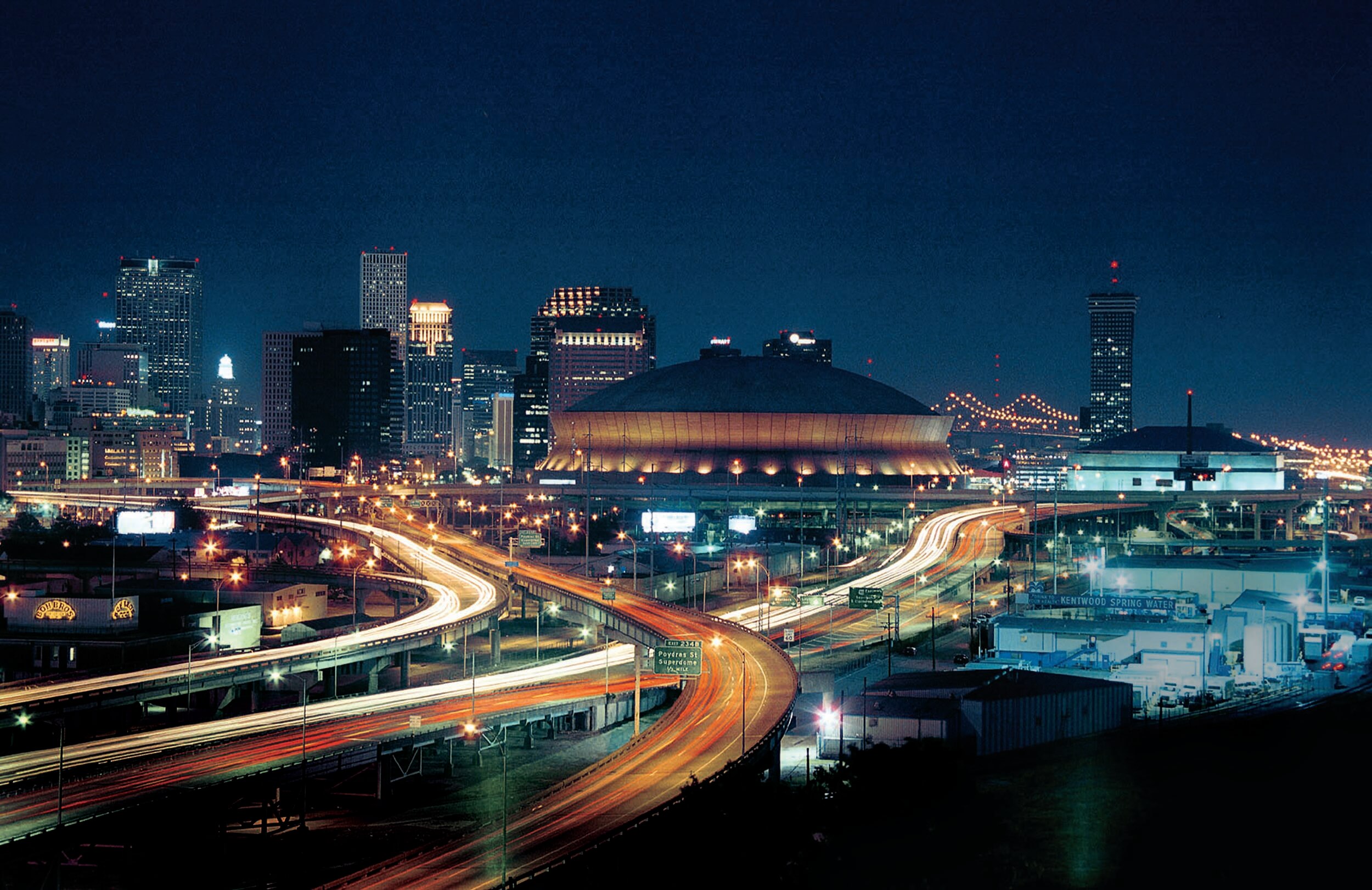 The Mercedes Benz superdome shines against the backdrop of the New Orleans skyline