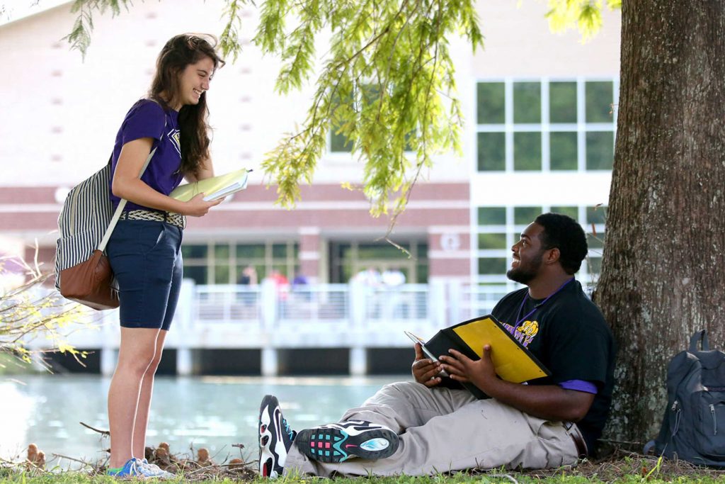 Two students sitting on campus in greater New Orleans, LA