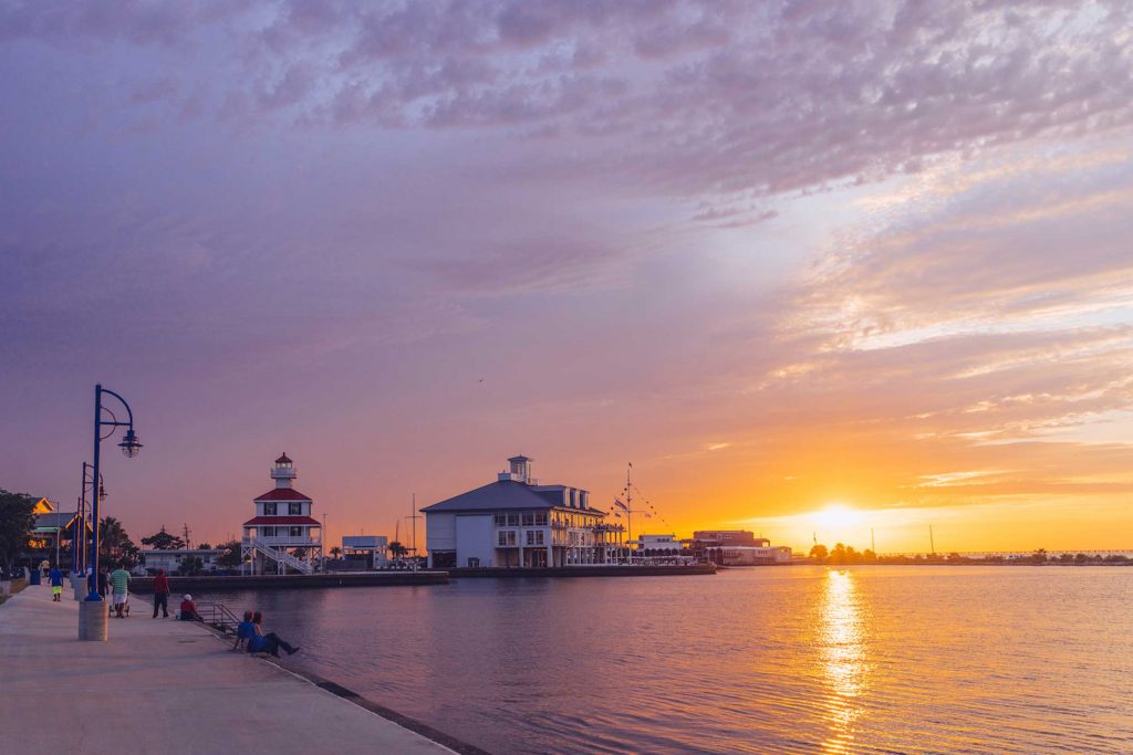 The sun sets over the harbor in in greater New Orleans, LA